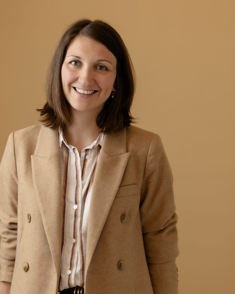 Marni standing in a camel blazer