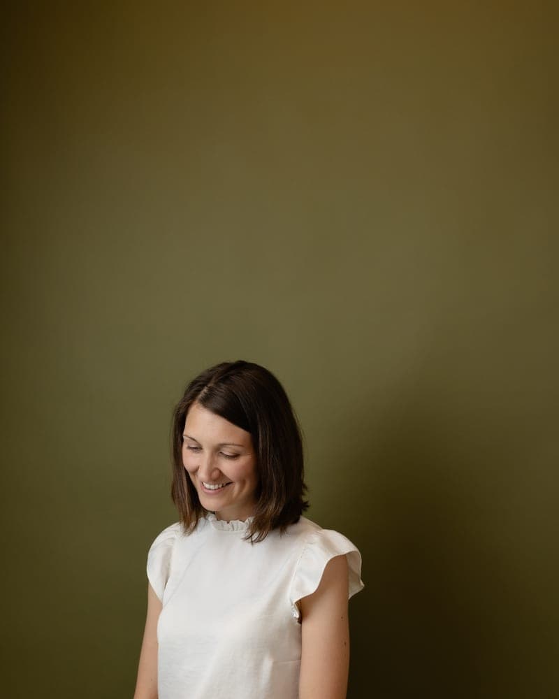 Marni seated, glancing down
